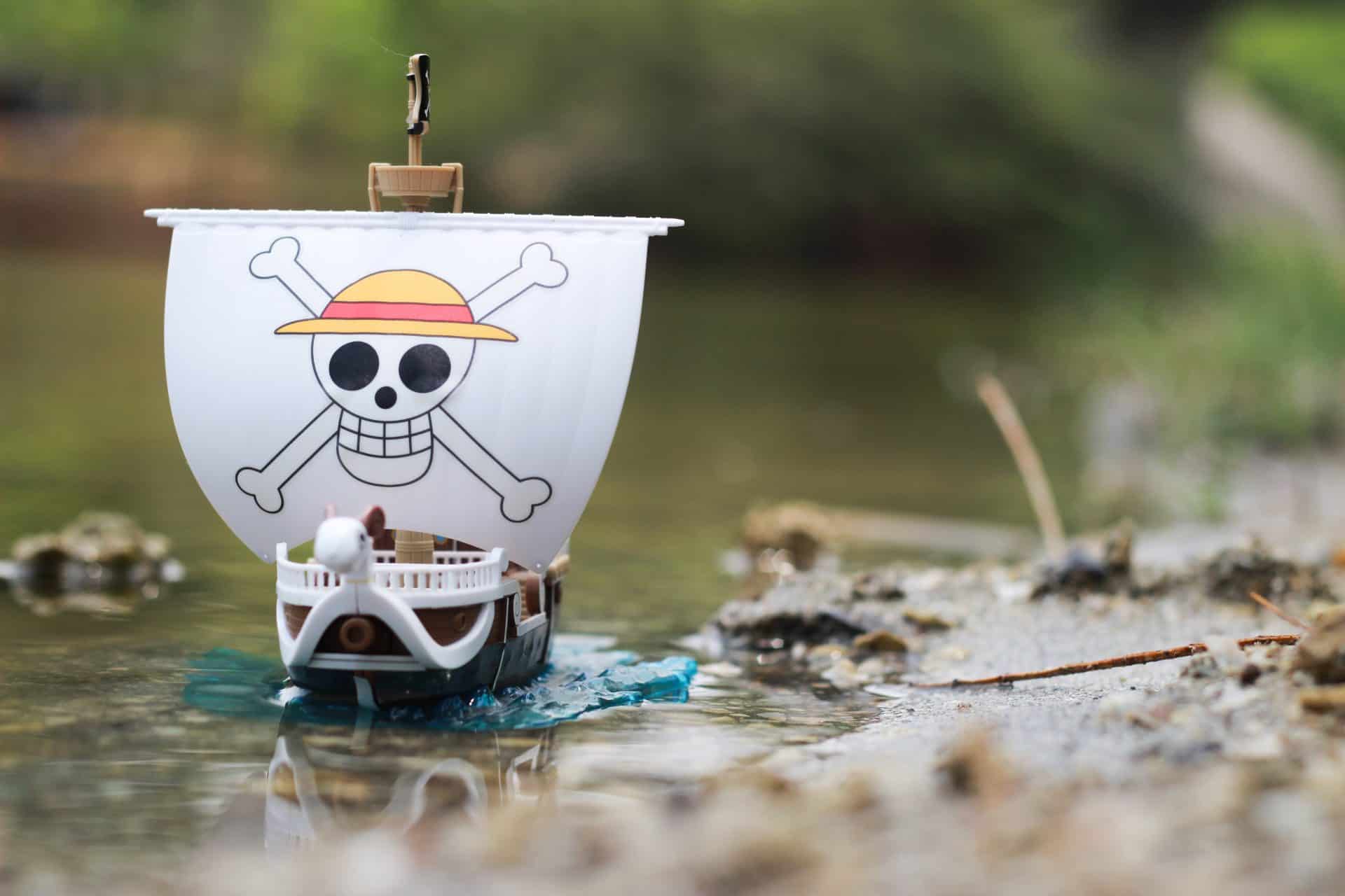 one-piece-toy-ship-going-merry-on-natural-green-river-scaled